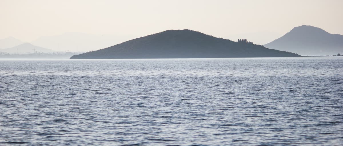 Isla Perdiguera seen across the calm water of the Mar Menor